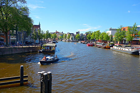 white and black boat on body of water under blue skies thumbnail