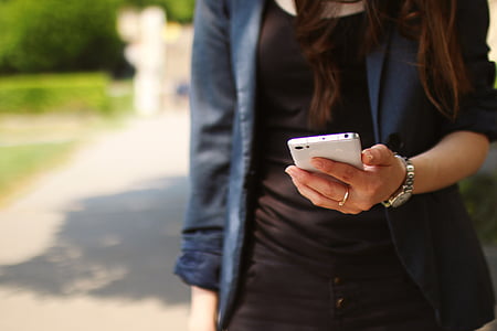 woman holding white smartphone thumbnail