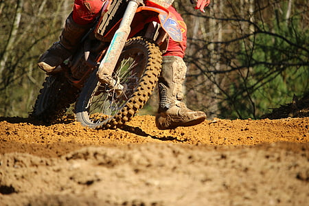 person riding on red motocross dirt motorcycle during daytime thumbnail