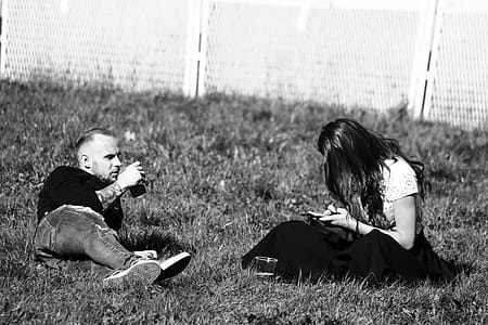 Grayscale Photography of Man and Woman on Grass thumbnail