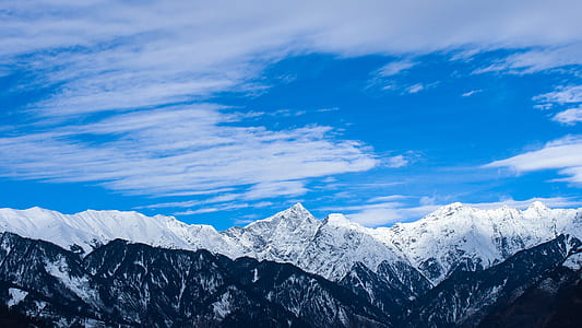 aerial photo of snow covered mountain during daytime thumbnail