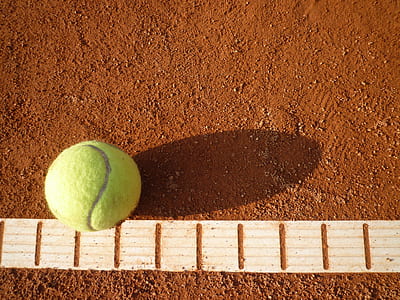 tennis ball on soil pavement thumbnail