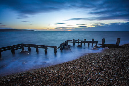 body of water under cloudy sky during daytime thumbnail