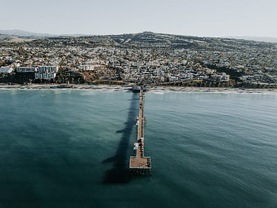 aerial photography of brown wooden dock on body of water thumbnail