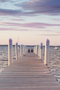 two person sitting on the ocean dock thumbnail