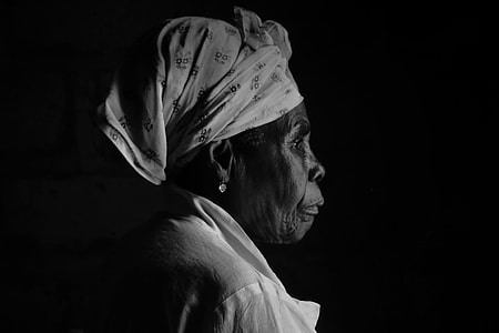photo of woman with headwrap and white top with black background portrait thumbnail
