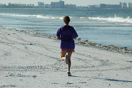 person in blue top and red shorts standing near body of water during daytime thumbnail