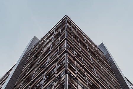 low angle photo of brown concrete building during daytime thumbnail