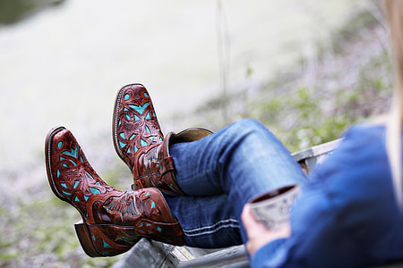 person in brown leather boots thumbnail