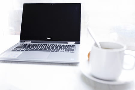 Dell Laptop in Front of Cup of Coffee thumbnail