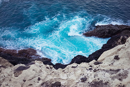 body of water near rock formation thumbnail