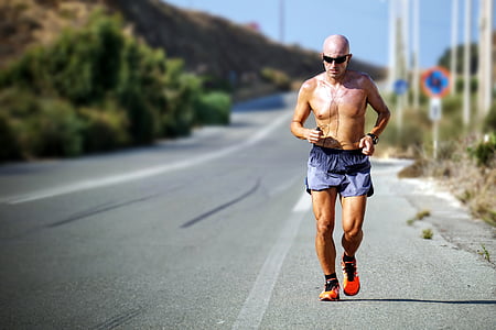 man wearing shorts running on pavement thumbnail