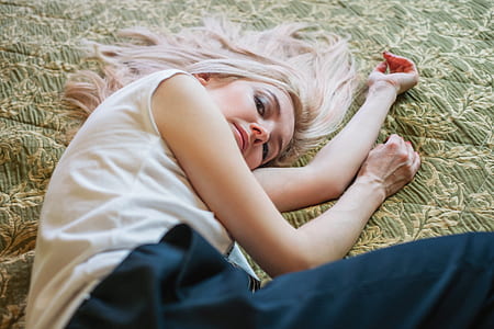 brown haired woman lying on green floral textile thumbnail
