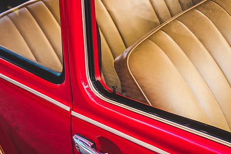 classic red vehicle with beige leather bucket seat thumbnail