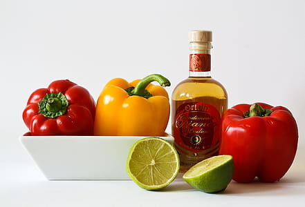 Red and Green Bell Pepper Inside White Ceramic Tray Near to Bottle and Lemon thumbnail