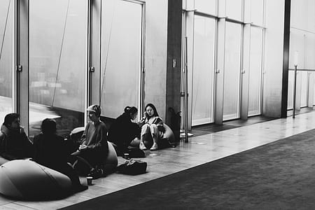 five person gathering beside glass wall thumbnail