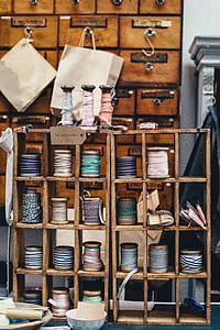 assorted-color ribbon spool in wooden rack thumbnail