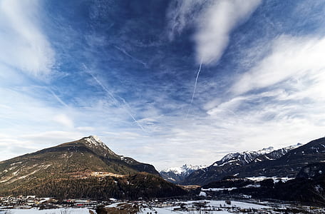 Green Mountain With Snow Field Under Blue Sky and White Clouds thumbnail
