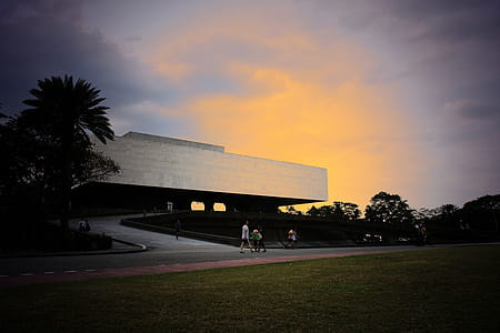 People Walking Near White Concrete Structure thumbnail