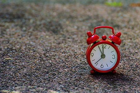 depth photography of red twin bell alarm clock thumbnail
