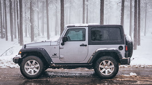 gray and black Jeep Wrangler hatchback riding thumbnail