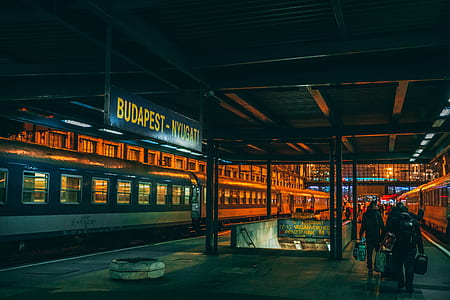 people holding bags near the train railway thumbnail