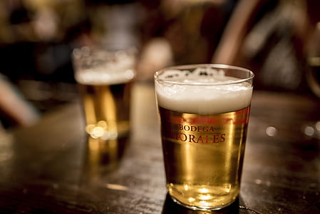glass of beer on brown wooden surface thumbnail