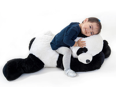 girl sitting on panda plush toy thumbnail
