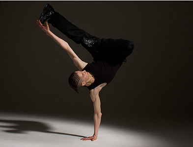 man wearing black tank top doing stunt on floor thumbnail