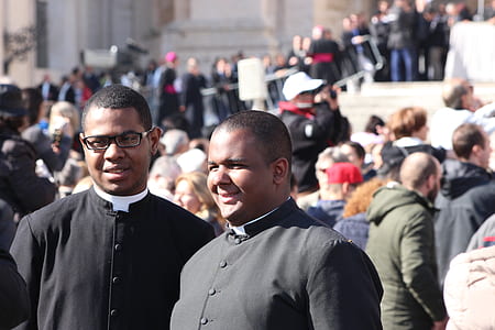 two men standing beside people thumbnail