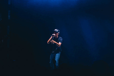 man wearing cap singing white using microphne thumbnail