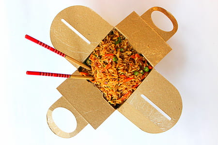 pair of brown-and-red chopsticks with food in the box thumbnail