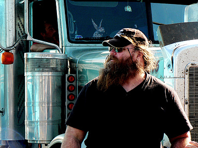 man standing in front of freight truck thumbnail