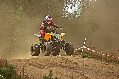 man riding ATV jumping on track thumbnail