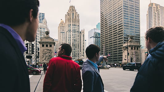 four men standing in city street thumbnail