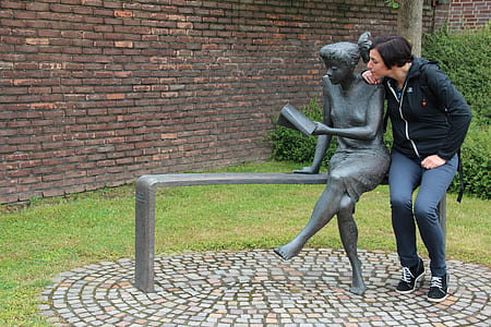 woman sitting next to statue outdoor thumbnail