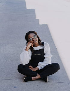 woman sitting on gray concrete floor thumbnail