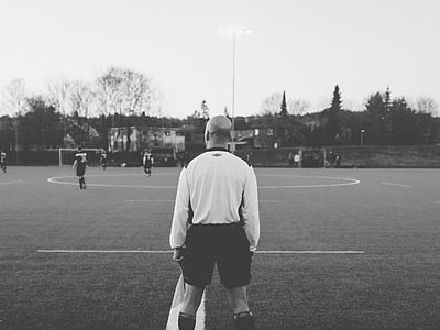 grayscale photography of referee standing in ballpark thumbnail