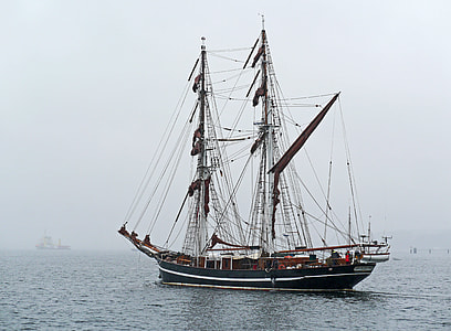 blue and black sail ship on sea thumbnail