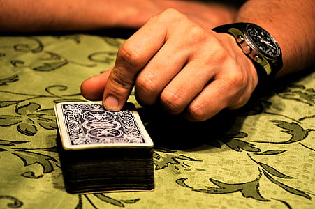 person holding deck of playing cards thumbnail