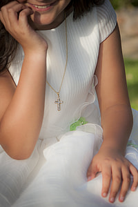 woman in white cap-sleeved shirt smiling for a photo thumbnail