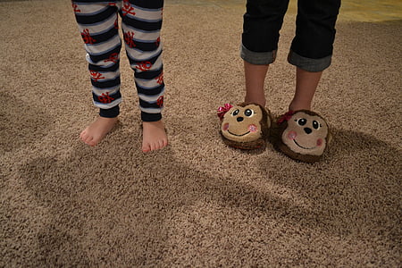 two children standing on brown rug thumbnail