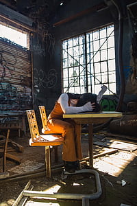 woman lying on table while sitting inside warehouseduring daytime thumbnail