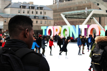 tilt shift lens photography of man standing near Toronto free standing decoration thumbnail