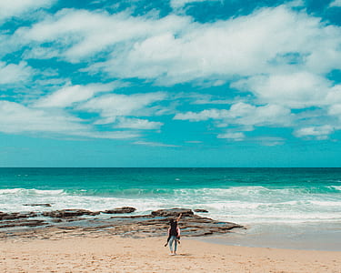 man carrying woman on shore thumbnail