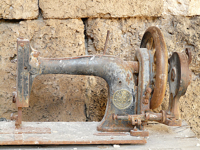 black treadle sewing machine on brown wood thumbnail