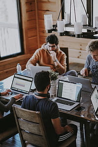 group of people in front laptop on brown wooden table thumbnail