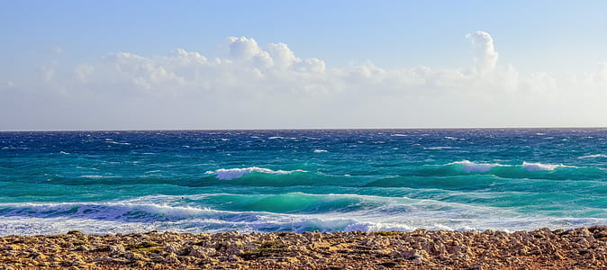 blue ocean under cloudy sky thumbnail