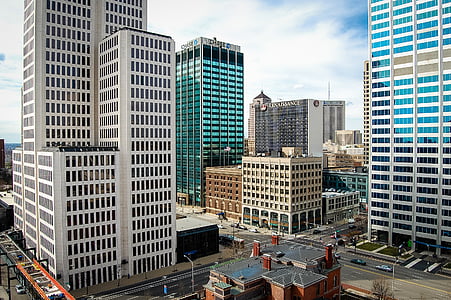 gray high-rise buildings under white clouds thumbnail