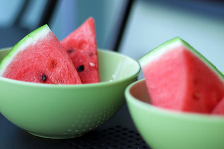 two green bowl of sliced water melons thumbnail